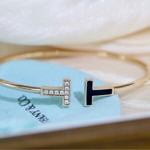 Elegant Gold and Black T Bracelet